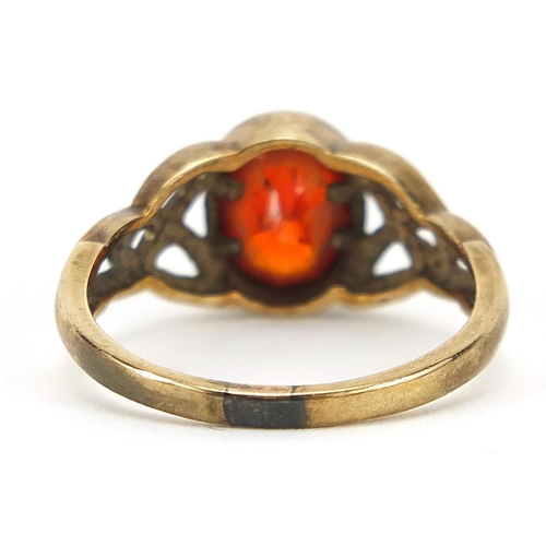 229 - 9ct gold orange stone ring with Celtic design shoulders, size M, 3.1g