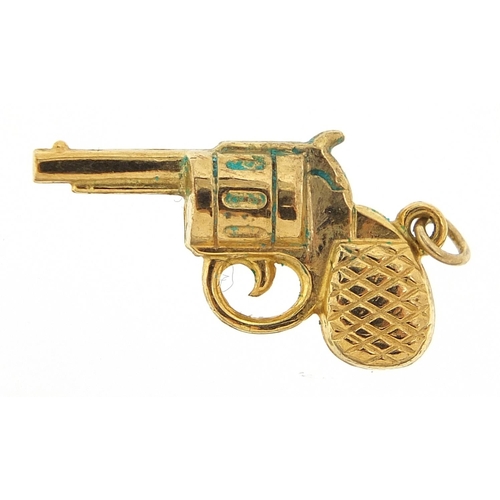 298 - 9ct gold revolver charm, 2.5cm wide, 1.0g