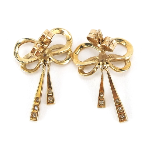 216 - Pair of 9ct gold diamond and white sapphire bow design earrings, 2.0cm high, 2.1g