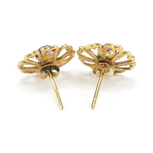 69 - Pair of unmarked gold purple stone flower head stud earrings, 1.3cm in diameter, 1.5g