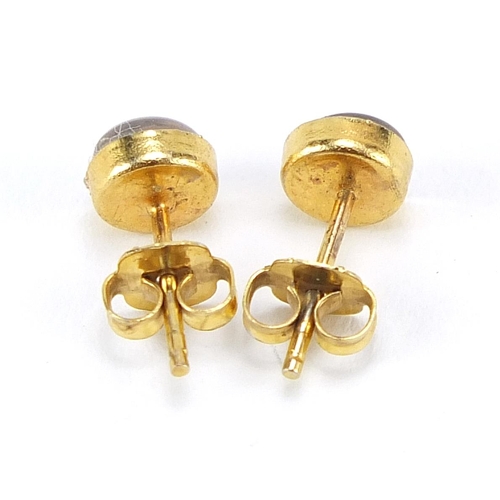 153 - Pair of yellow metal cabochon opal stud earrings, (tests as 9ct gold) 5mm in diameter, 0.8g