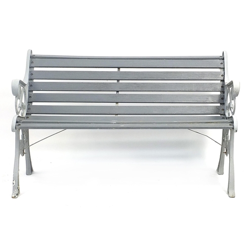 1496 - Painted cast iron and wooden slat garden bench, 129cm in length