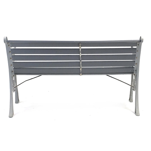 1496 - Painted cast iron and wooden slat garden bench, 129cm in length