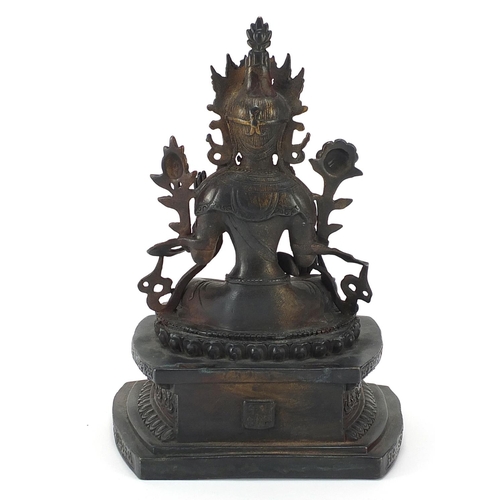 307 - Chino Tibetan patinated bronze figure of Buddha, character marks to the reverse, 27cm high