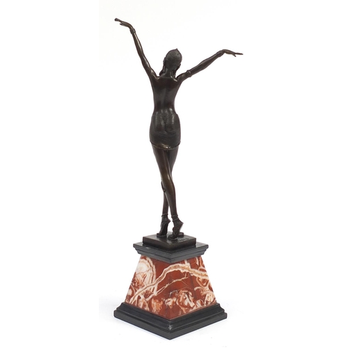 1168 - Large patinated bronze figurine of an Art Deco dancer raised on a tapering marble and black slate ba... 