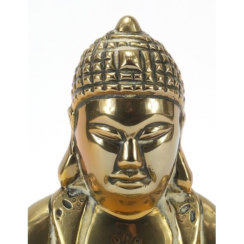 140 - Chinese bronzed figure of Buddha raised on a carved hardwood lotus stand, 23.5cm high