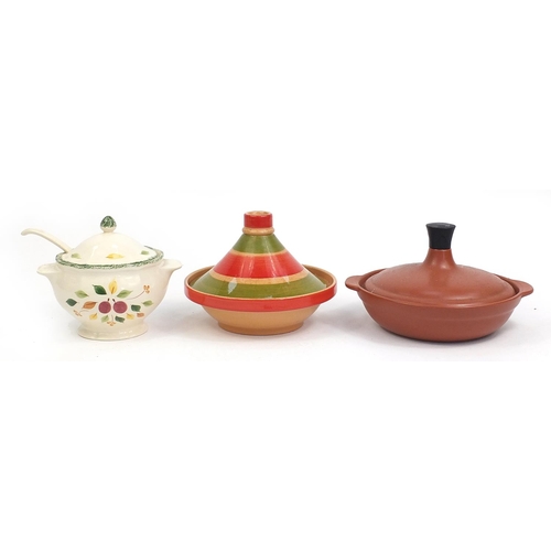 116 - Two pottery tagines and a floral pottery soup bowl with ladle and cover, the largest 25cm high