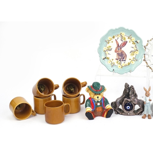 93 - Animal related ceramics and statues including teddy money box, rabbit plate, rabbit basket, cat teap... 