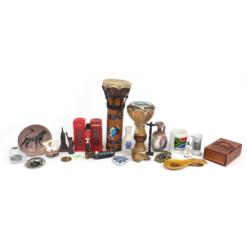 84 - Assorted souvenir items including British red telephone boxes, Greek pottery vase, tribal drum, Sout... 