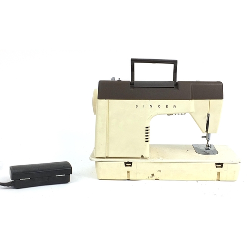 220 - Cased Singer electric sewing machine