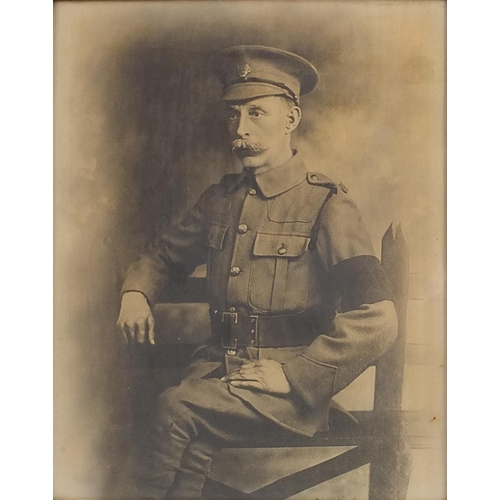 229 - Black and white print World War I military soldier in uniform, mounted in a carved oak frame, overal... 