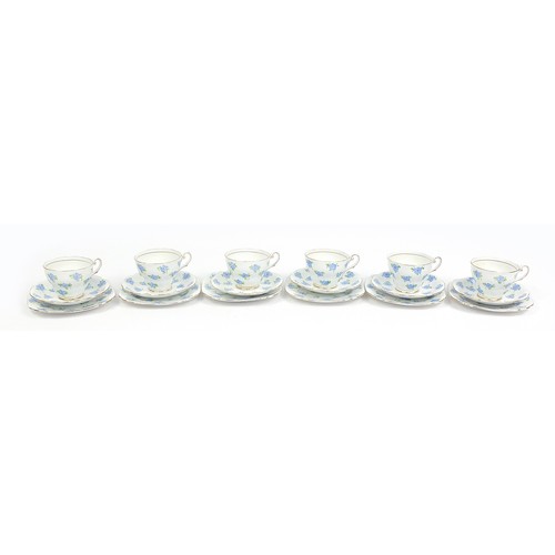 171 - Six bone china floral trios hand painted with stylised blue flowers