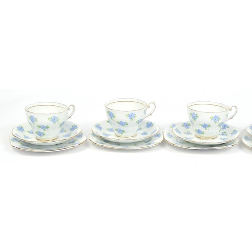 171 - Six bone china floral trios hand painted with stylised blue flowers