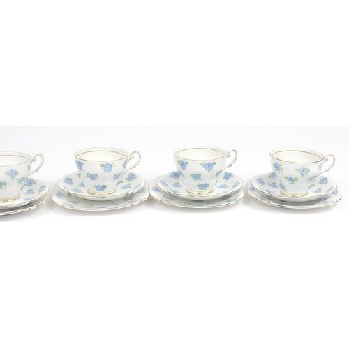 171 - Six bone china floral trios hand painted with stylised blue flowers