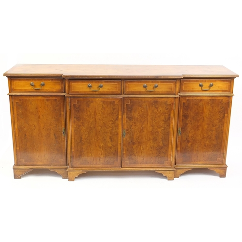 81 - Crossbanded yew breakfront sideboard with four drawers above four cupboard doors, 90cm H x 182cm W x... 