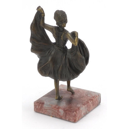 656 - Patinated bronze figurine of an Art Deco dancer with lift up skirt, raised on a square marble base, ... 