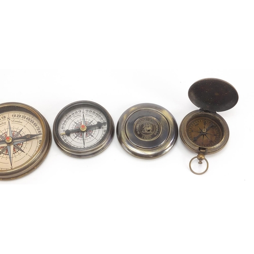 664 - Four brass nautical interest compasses and sun dials, the largest 7.5cm in diameter