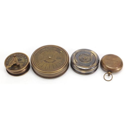 664 - Four brass nautical interest compasses and sun dials, the largest 7.5cm in diameter