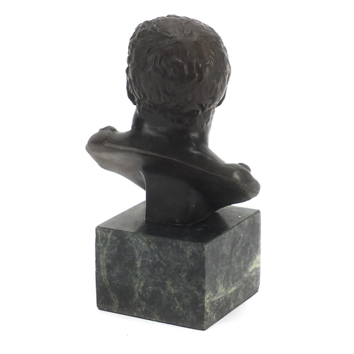 623 - Patinated bronze bust of a Roman Emperor raised on a green marble base, 14cm high