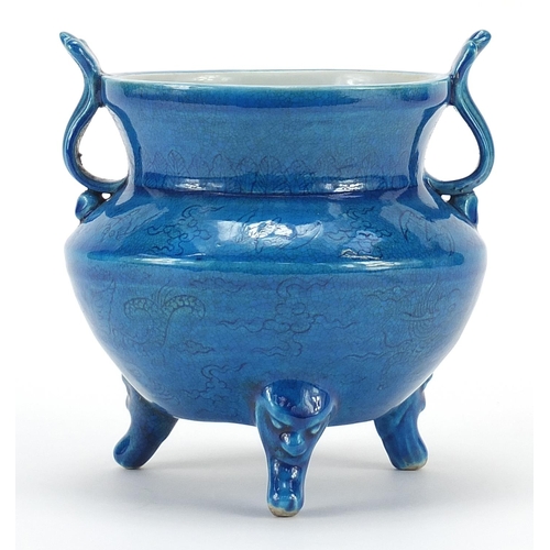 1088 - Chinese blue glazed porcelain tripod censer with twin handles incised with mythical animals, six fig... 