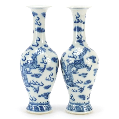 146 - Pair of Chinese blue and white porcelain vases hand painted with dragons amongst clouds, four figure... 