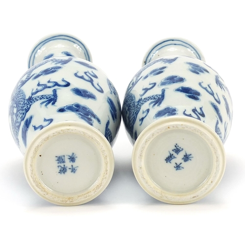 146 - Pair of Chinese blue and white porcelain vases hand painted with dragons amongst clouds, four figure... 