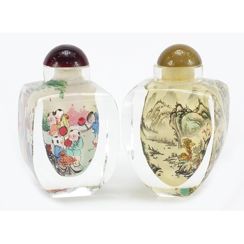 946 - Two Chinese glass snuff bottles internally hand painted with children and a river landscape, each 8.... 