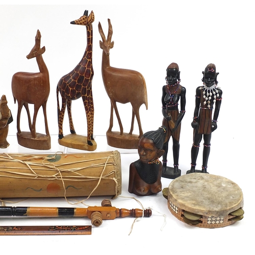 760 - Wooden items including African figures, animals, instruments and large carved wall mask, the largest... 