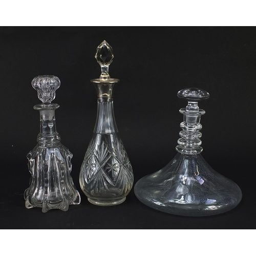 1149 - Three cut glass decanters including one with silver collar, the largest 34cm high