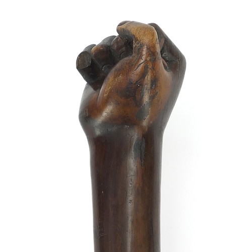 1013 - African Tribal interest hardwood club with carved clenched fist, possibly lignum vitae. 53.5cm in le... 