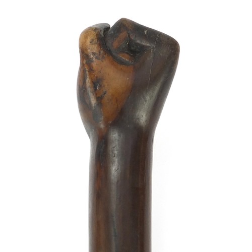 1013 - African Tribal interest hardwood club with carved clenched fist, possibly lignum vitae. 53.5cm in le... 