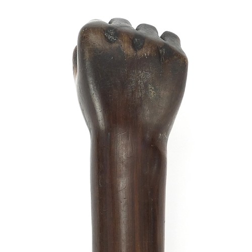 1013 - African Tribal interest hardwood club with carved clenched fist, possibly lignum vitae. 53.5cm in le... 