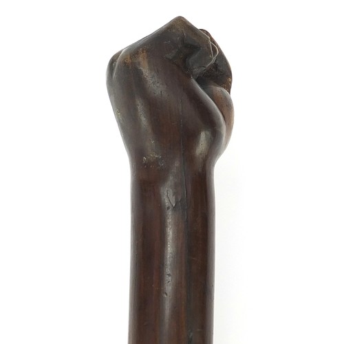 1013 - African Tribal interest hardwood club with carved clenched fist, possibly lignum vitae. 53.5cm in le... 