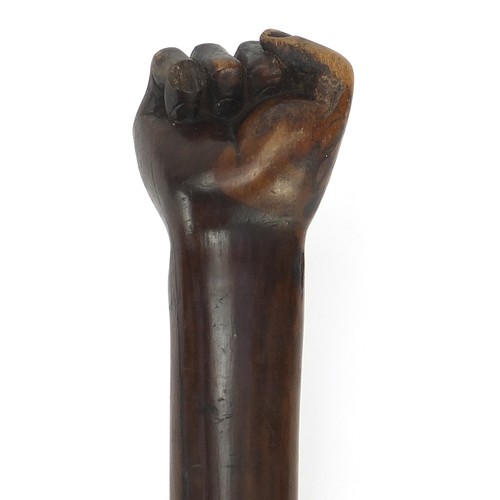 1013 - African Tribal interest hardwood club with carved clenched fist, possibly lignum vitae. 53.5cm in le... 