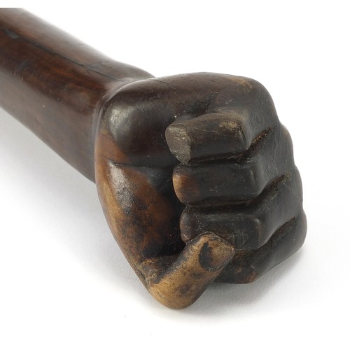 1013 - African Tribal interest hardwood club with carved clenched fist, possibly lignum vitae. 53.5cm in le... 