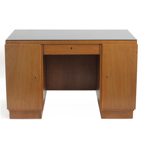 840 - Manner of Heals, Art Deco oak desk with lift of glass top and two doors enclosing drawers and shelf ... 