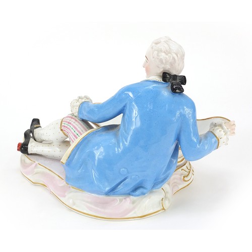 942 - 19th century porcelain figural sweetmeat dish in the form of a young man in Georgian dress, hand pai... 