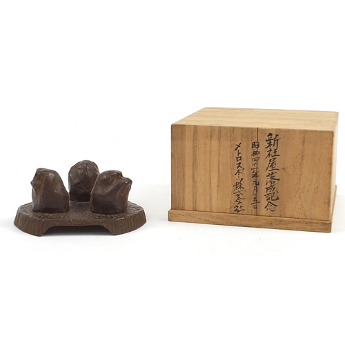 1136 - Contemporary Japanese iron sculpture of the three wise monkeys with wooden box, 12.5cm wide