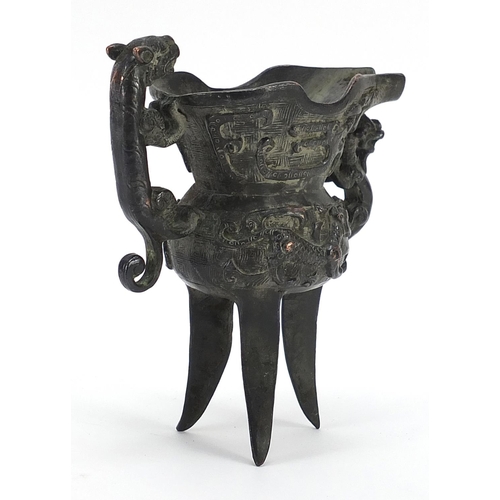 147 - Chinese patinated bronze tripod wine vessel with animalia handle, impressed character marks to the b... 