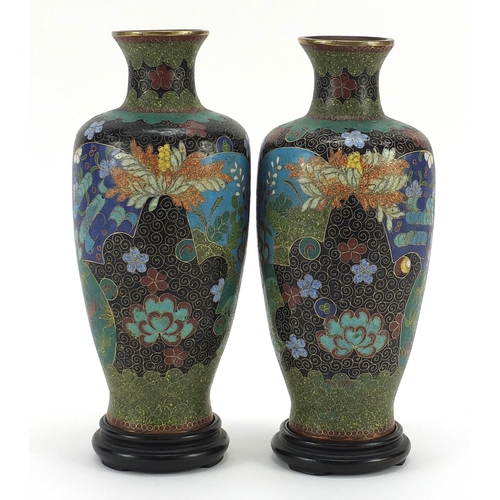 27 - Pair of Japanese cloisonne vases on hardwood stands, each enamelled with flowers within fan motifs, ... 