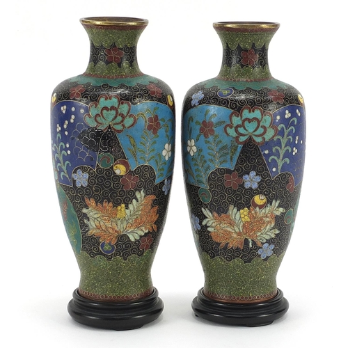 27 - Pair of Japanese cloisonne vases on hardwood stands, each enamelled with flowers within fan motifs, ... 