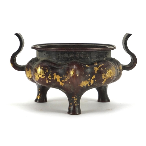 203 - Chinese gold splashed patinated bronze tripod censer with twin handles, 16cm wide