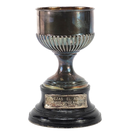 2268 - Spanish silver equestrian interest trophy raised on an ebonised wood base, 17.5cm high, total weight... 