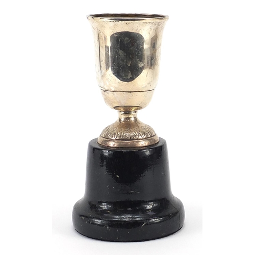 2240 - Spanish silver equestrian interest trophy raised an ebonised wood base, 22cm high, total weight 414g