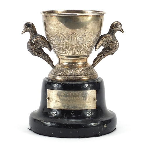 2264 - Spanish silver equestrian interest trophy with twin bird design handles raised on an ebonised wood b... 