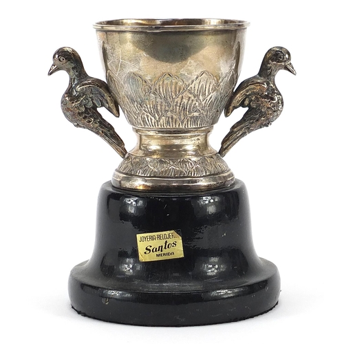 2264 - Spanish silver equestrian interest trophy with twin bird design handles raised on an ebonised wood b... 