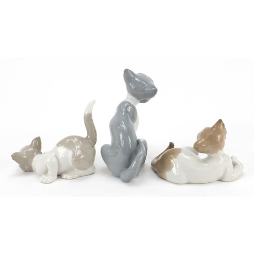 528 - Three Lladro cats, the largest 14cm high