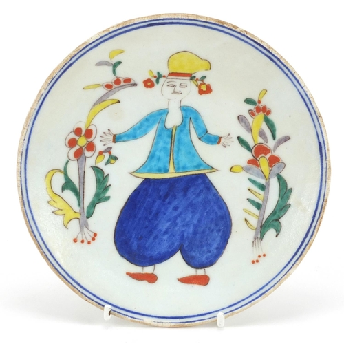 63 - Turkish Kutahya pottery plate hand painted with a figure, 16cm in diameter