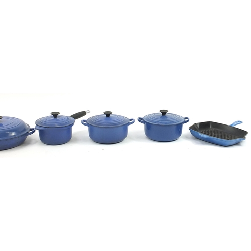 1022 - Group of vintage Le Creuset cast iron and stoneware pans and saucepans, the largest 37cm wide