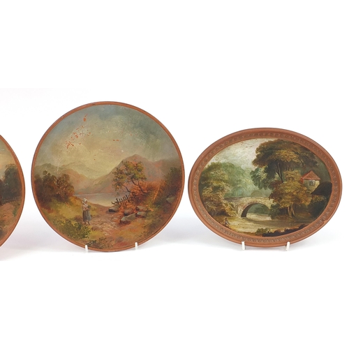 1353 - Two pairs of Watcombe terracotta plaques hand painted with pastoral scenes, the largest each 25cm wi... 